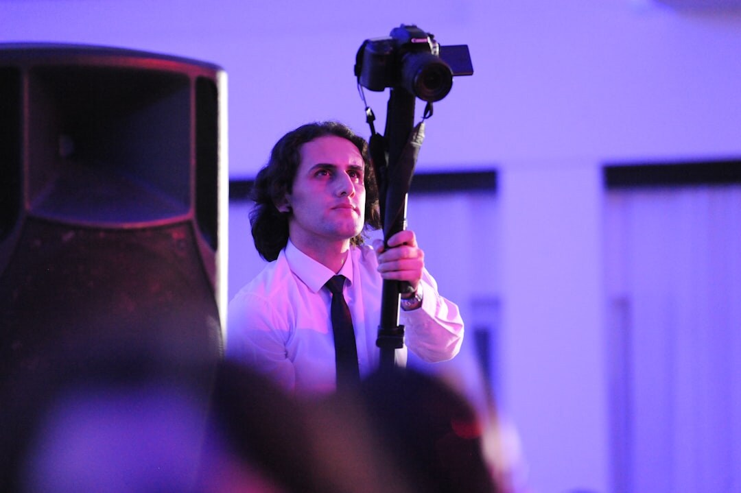 Journalist interviewing with microphone in front of camera