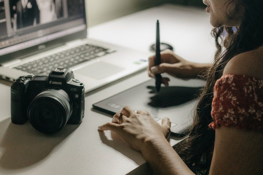 Journalist working with tablet and laptop on digital content